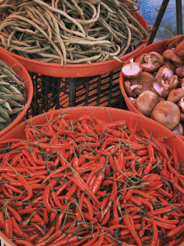 Crafting Captivating Headlines: Your awesome post title goes here Baskets of fresh vegetables including peppers, beans, and mushrooms at a local market stall.